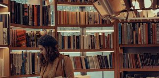 A woman browses books at a bookstore