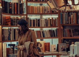 A woman browses books at a bookstore