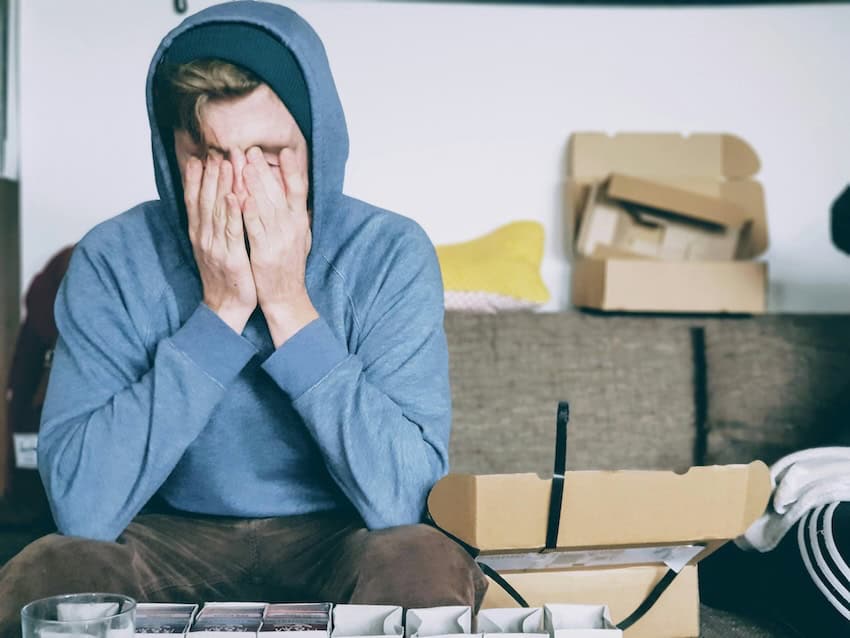 Man holding his head in his hands.