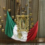 The Mexican flag alongside the Virgin of Guadalupe