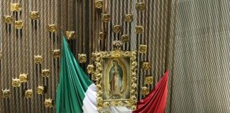 The Mexican flag alongside the Virgin of Guadalupe