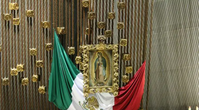 The Mexican flag alongside the Virgin of Guadalupe