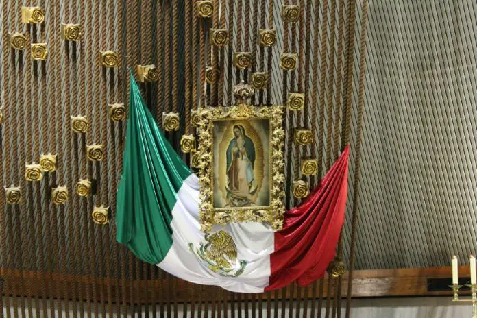 The Mexican flag alongside the Virgin of Guadalupe