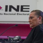 Mexico's elections chief Guadalupe Taddei stands in front of a sign reading "INE: Instituto Nacional Electoral"