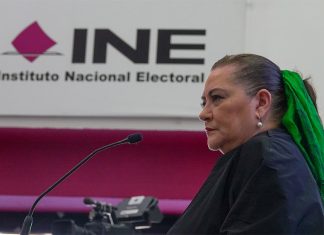 Mexico's elections chief Guadalupe Taddei stands in front of a sign reading "INE: Instituto Nacional Electoral"