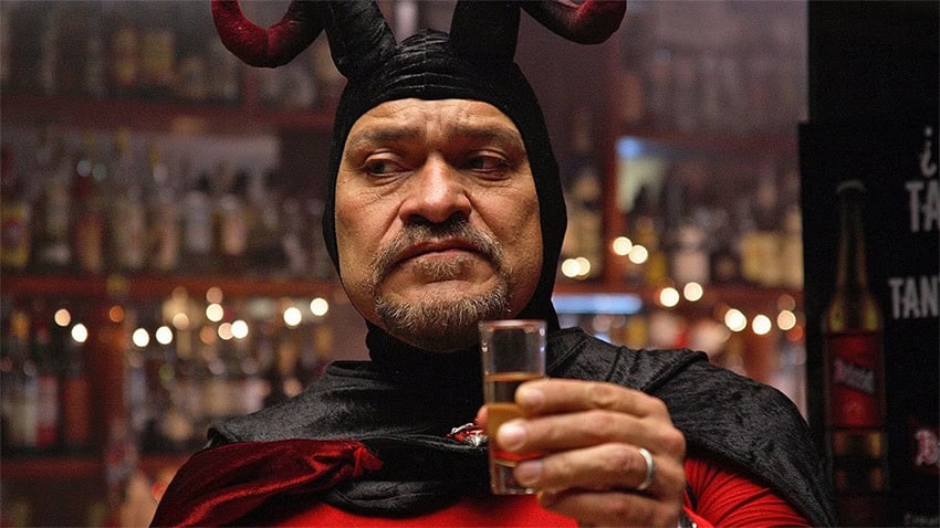 Joaquín Cosío, dressed as a devil, raises a shot glass in "Pastorela," one of the best Mexican movies or TV shows MND staff watched this year