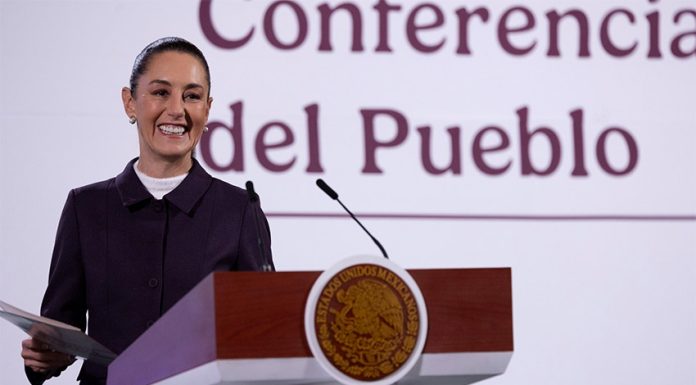 President Claudia Sheinbaum smiles from the podium during her morning press conference, or mañanera