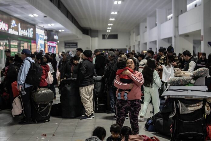 Mexicans wait for transport at the Tijuana Bus Terminal in December 2024