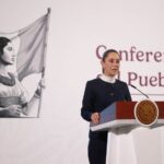 President Claudia Sheinbaum stands at a podium during her morning press conference, where she talked about the event to celebrate her first 100 days in office