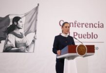 President Claudia Sheinbaum stands at a podium during her morning press conference, where she talked about the event to celebrate her first 100 days in office