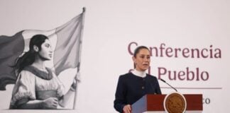 President Claudia Sheinbaum stands at a podium during her morning press conference, where she talked about the event to celebrate her first 100 days in office