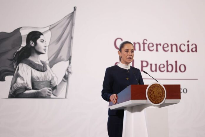 President Claudia Sheinbaum stands at a podium during her morning press conference, where she talked about the event to celebrate her first 100 days in office