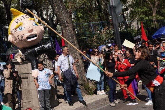 Protesters attacking a piñata of Donald Trump on Jan. 20, 2025