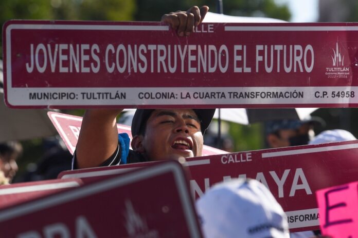 A women holding up a sign saying 