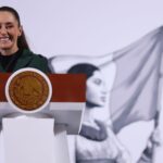 Mexico's President Claudia Sheinbaum smiling as she talks to reporters at the National Palace at a press conference