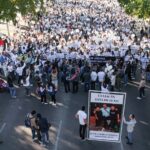 Hundreds of protesters in white can be seen gathered around a banner reading "Culiacán está en luto"