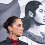 Side profile photo of Mexican President Claudia Sheinbaum at a press conference, standing in a parallel position to her admnistration's logo, a illustration in profile of a young Mexican Indigenous woman standing in front of the Mexican flag