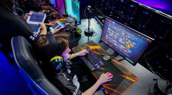 A young gamer plays a computer game, part of Phygital Games Mexico