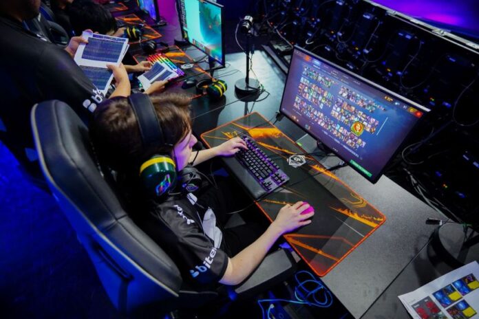 A young gamer plays a computer game, part of Phygital Games Mexico