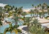 Palms surround an irregularly shaped pool next to the ocean at Hilton's Conrad hotel in Punta Mita.