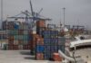 Shipping containers in many different colors waiting in stacks to be loaded at the Port of Enenada.