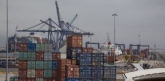 Shipping containers in many different colors waiting in stacks to be loaded at the Port of Enenada.