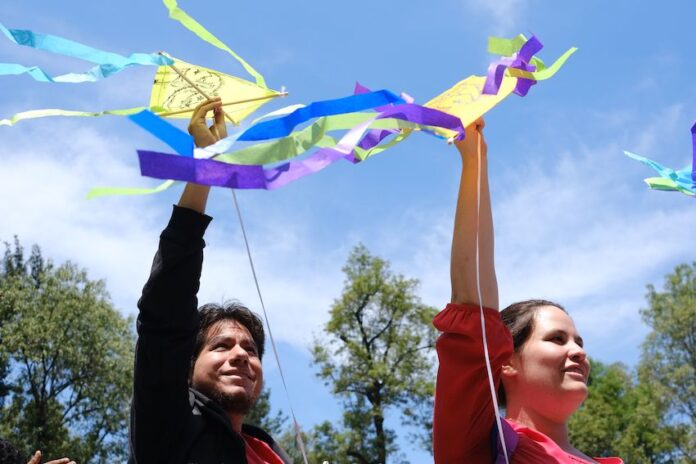 People holding kites