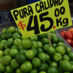 A pile of limes with a sign that reads "Pura calidad, $45 por kg," illustrating the decrease in inflation in Mexico