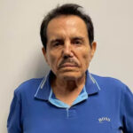 Mugshot of Sinaloa Cartel cofounder Ismael "El Mayo" Zambada, wearing a blue Boss brand polo shirt as he stares into the camera unsmiling