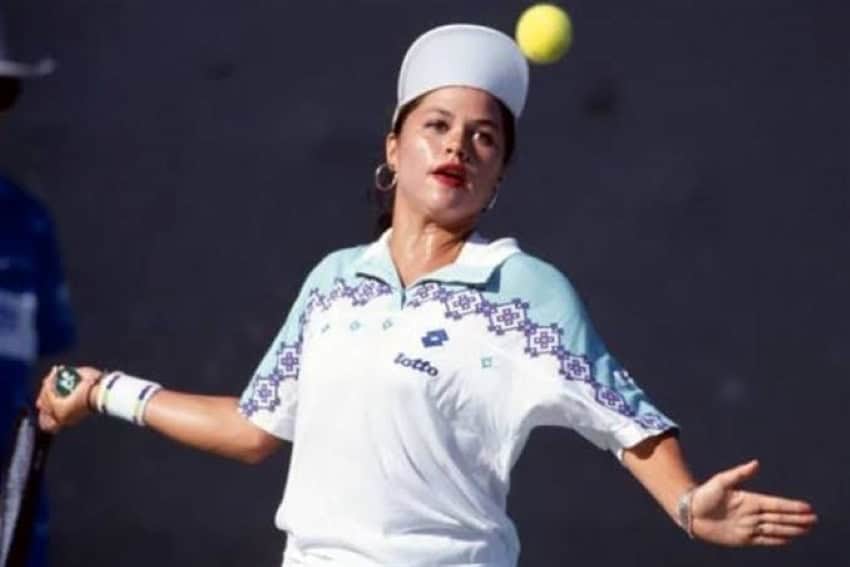 Mexican-American tennis player Angelica Gavaldon as a 16-year-old, about to hit a ball in the air at a match at the Australian Open in 1990.