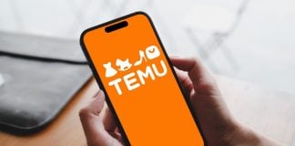 A person holds a phone with a Temu e-commerce application open on the screen