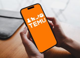 A person holds a phone with a Temu e-commerce application open on the screen