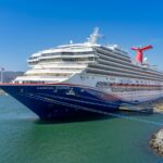 A blue and white Carnival cruise ship in the port of Ensenada, Mexico