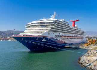 A blue and white Carnival cruise ship in the port of Ensenada, Mexico