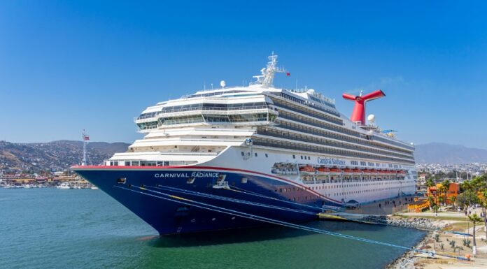 A blue and white Carnival cruise ship in the port of Ensenada, Mexico