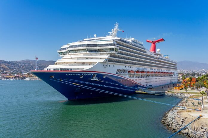 A blue and white Carnival cruise ship in the port of Ensenada, Mexico