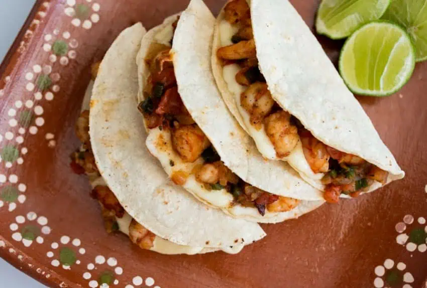 three tacos gobernador on brown ceramic plate, birds-eye view