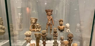Clay figures of women in a museum display case