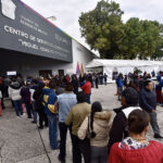 A long line of Toluca residents waits to file paperwork at a government office in Mexico