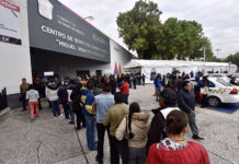 A long line of Toluca residents waits to file paperwork at a government office in Mexico