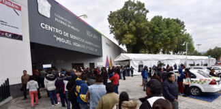 A long line of Toluca residents waits to file paperwork at a government office in Mexico