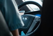 The steering wheel of a Chinese car showing the logo BYD