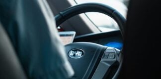 The steering wheel of a Chinese car showing the logo BYD