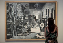 A woman contemplates the simplicity and balance of the Picasso painting "Las Meninas"