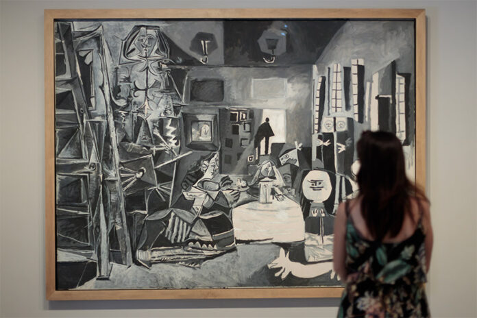 A woman contemplates the simplicity and balance of the Picasso painting 