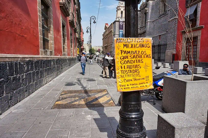 A hand-written sign advertises pambazos and other Mexico City specialties in downtown CDMX