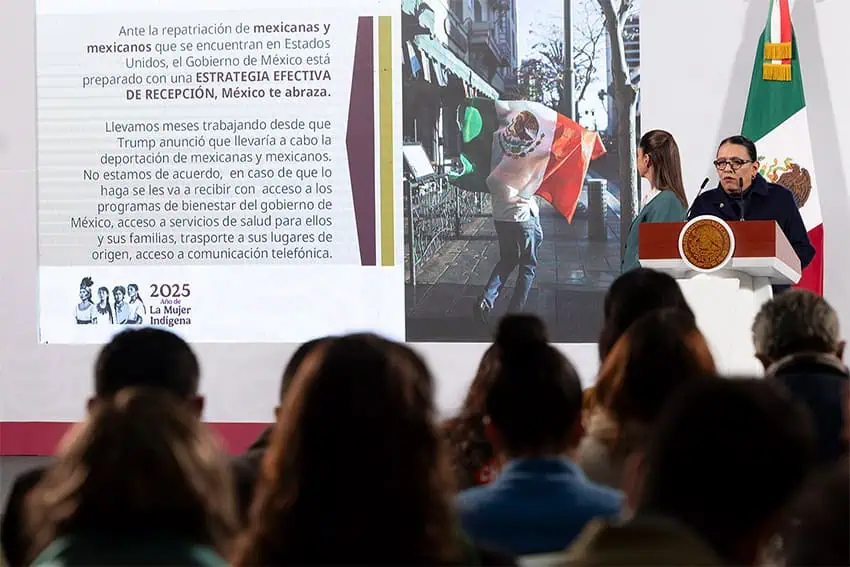 Mexico's interior secretary stands at a podium in front of information about Mexico te abraza, a program to help connect deported Mexicans with jobs and other resources