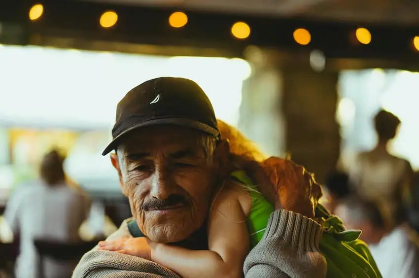 An old man hugging his granddaughter