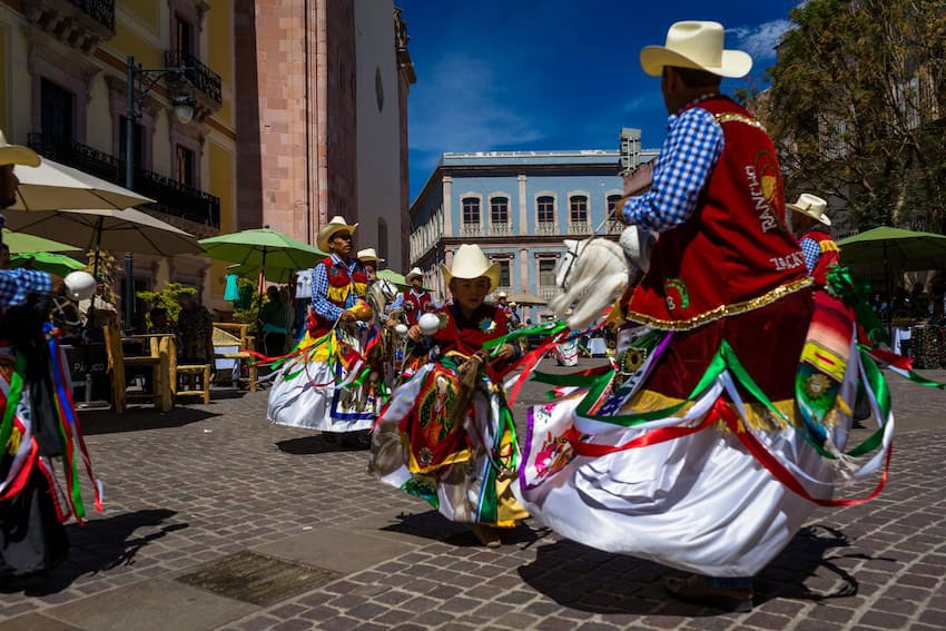 Local people in Zacatecas perform a traditional dance in the capital's main square.