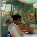 A man getting a haircut in a local salon